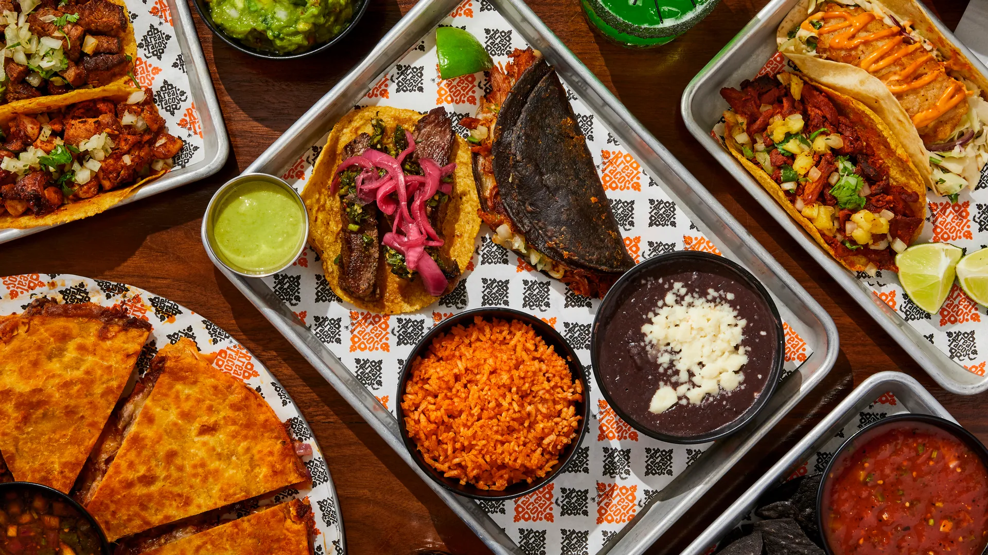 Rreal Tacos Halloween spread — tacos, quesadilla, rice and beans on a tray, with a spider-topped drink