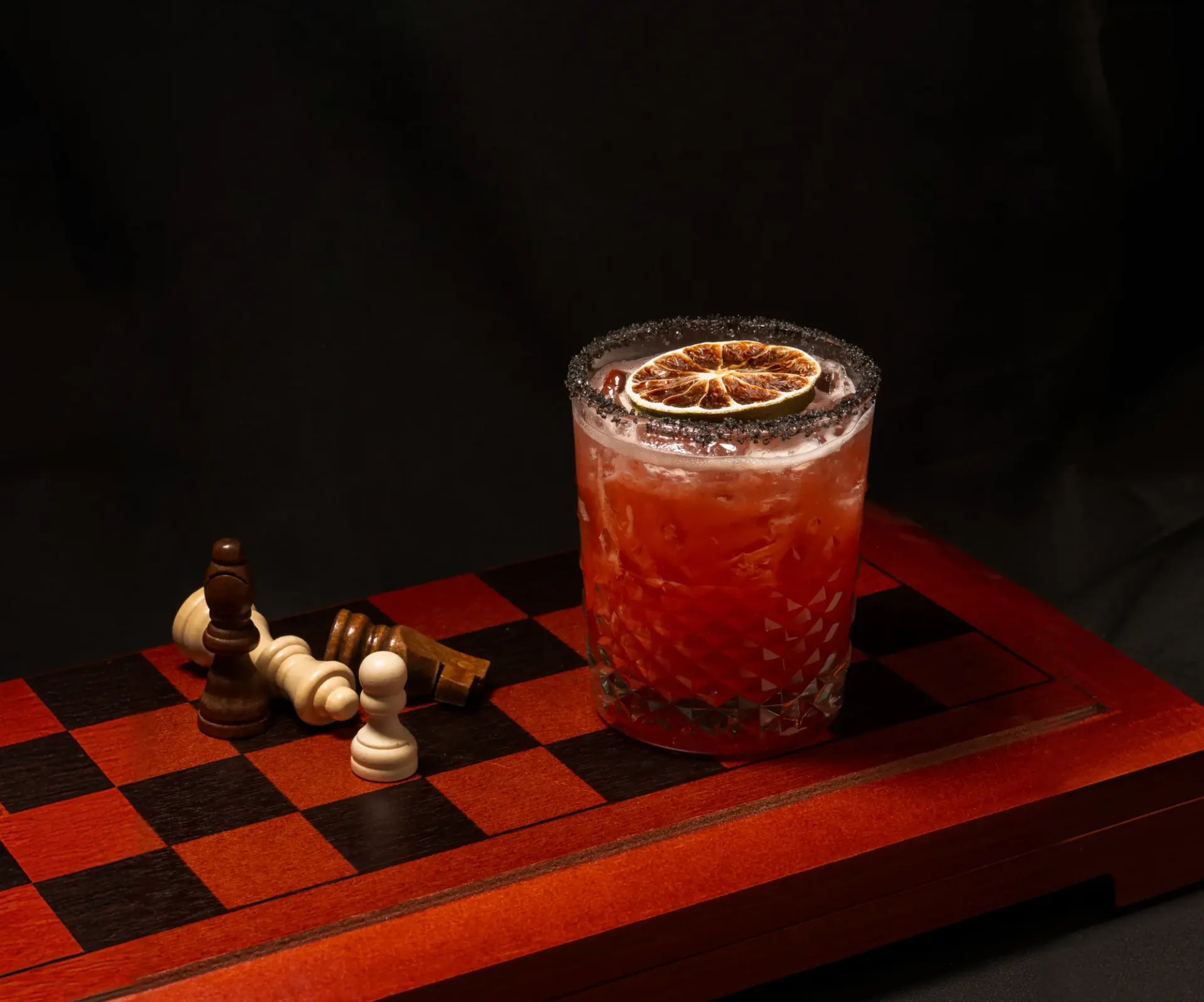 Rreal Tacos branded margarita on a chess-patterned surface