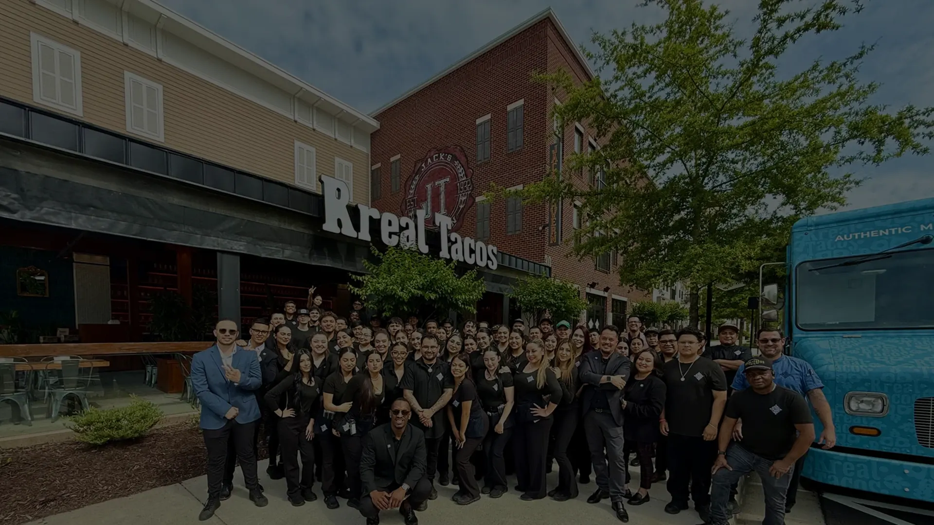 Rreal Tacos team posing together outside the restaurant
